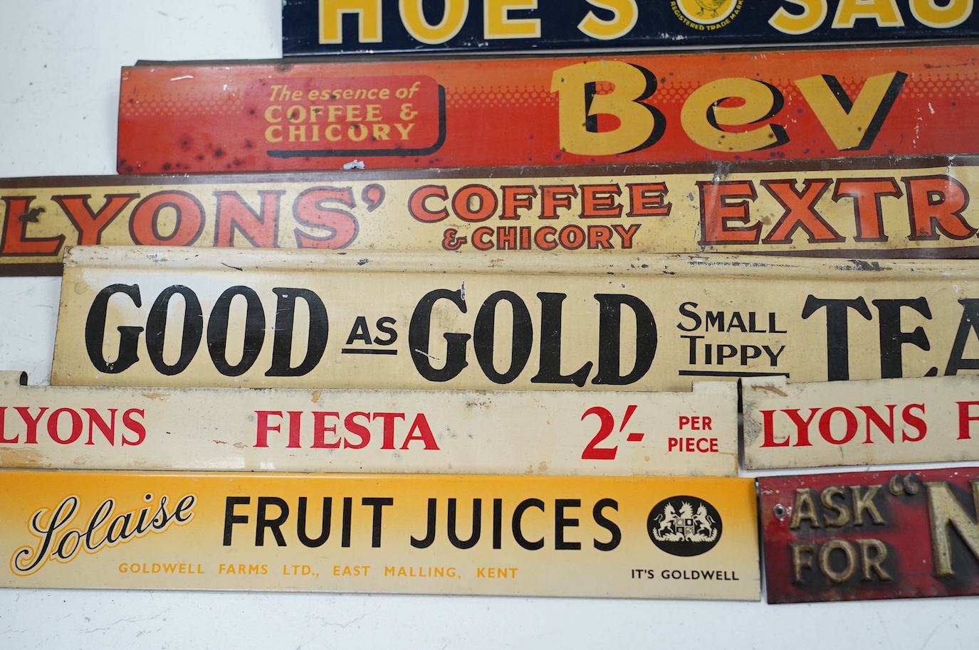 Eleven early / mid 20th century tinplate advertising shelf strips, largest 60cm. Condition - fair